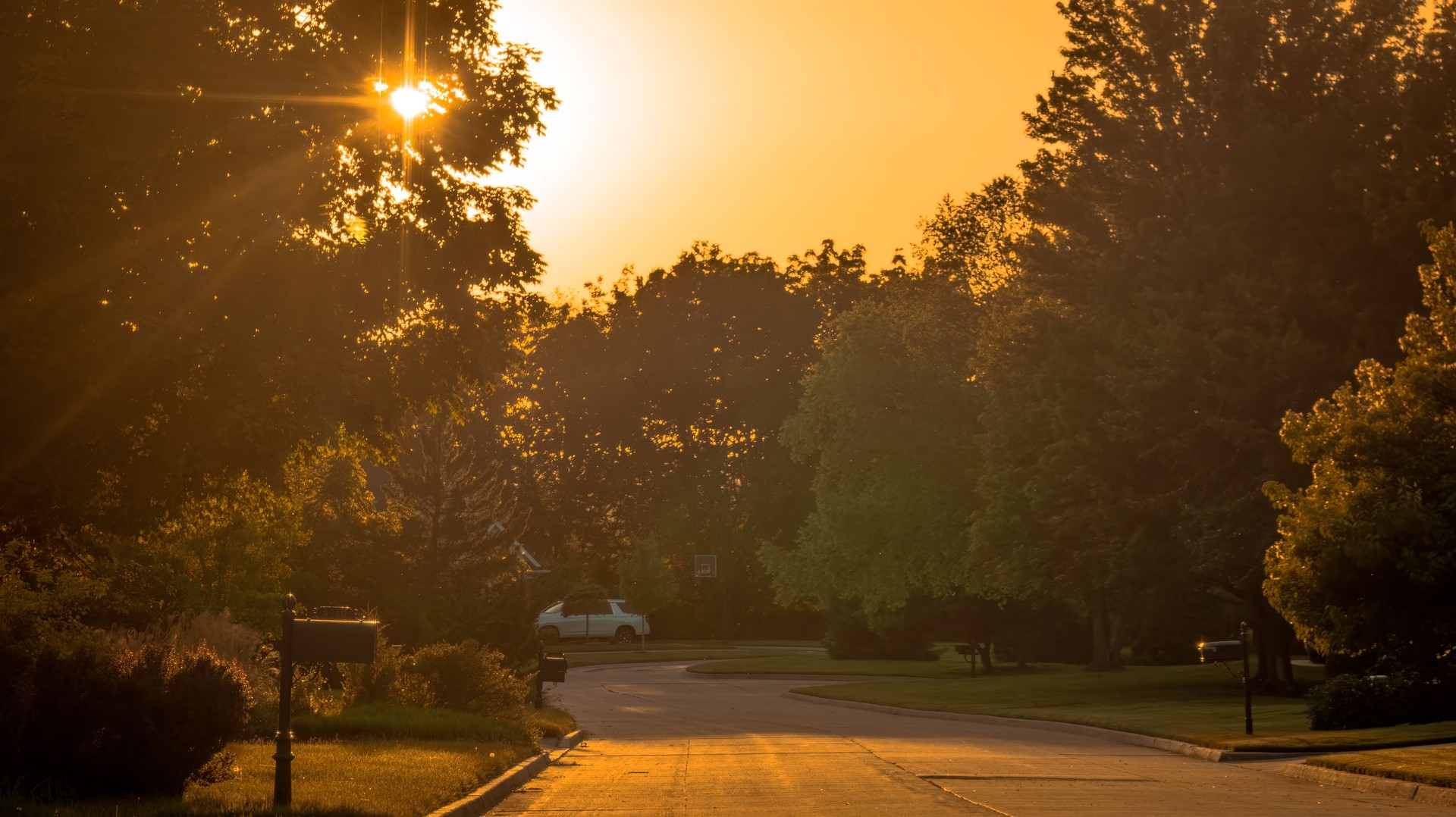 View of Midwestern suburban neighborhood at sunset in summer View of Midwestern suburban neighborhood at sunset in summer